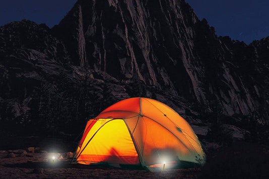 UCO StakeLight Tent Stake With LED Light and Emergency Strobe being used outside of a tent.